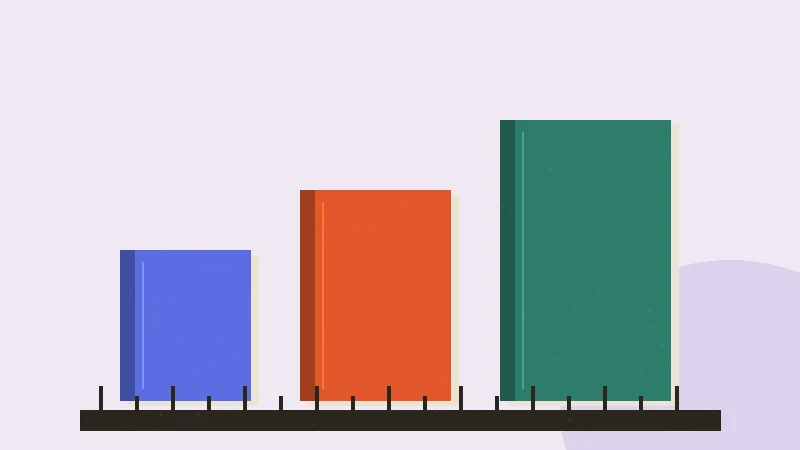 Short, medium, and tall books lined up beside a ruler